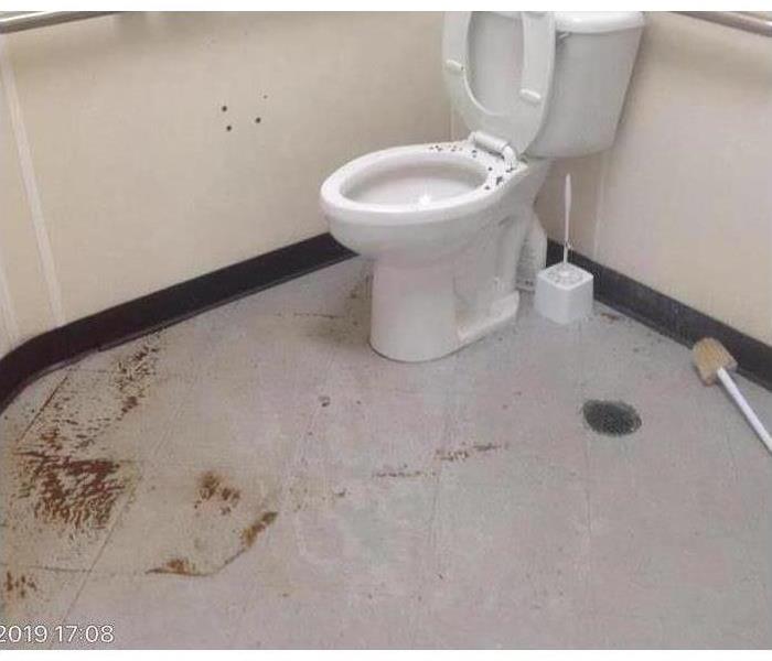 Bathroom with sewage on the floor.